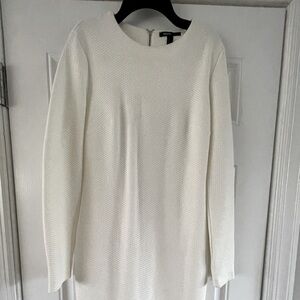 Knee length fitted dress with zipper details on sleeve and back zipper.